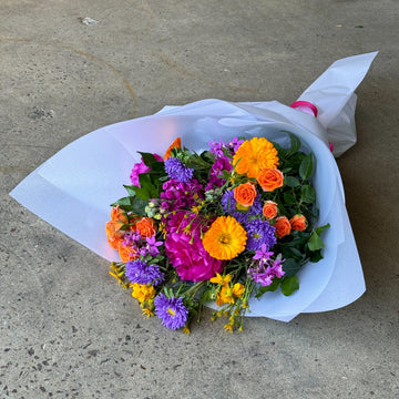 Bouquet of colorful flowers on a concrete surface
